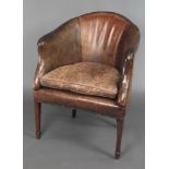 A tub back library chair upholstered in brown leather raised on square tapering supports