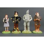 4 Royal Doulton figures from the Wizard of Oz - Dorothy 5 1/2", Scarecrow 6 1/4", Lion 6" and Tin