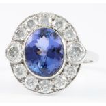 An 18ct white gold tanzanite and diamond cluster ring, the oval cut tanzanite approx. 2.60ct