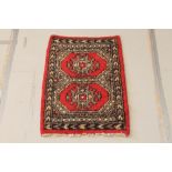 A red and white ground Uzbek "Bokhara" rug with 2 octagons to the centre 38" x 26"