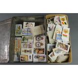 A collection of various cigarette cards