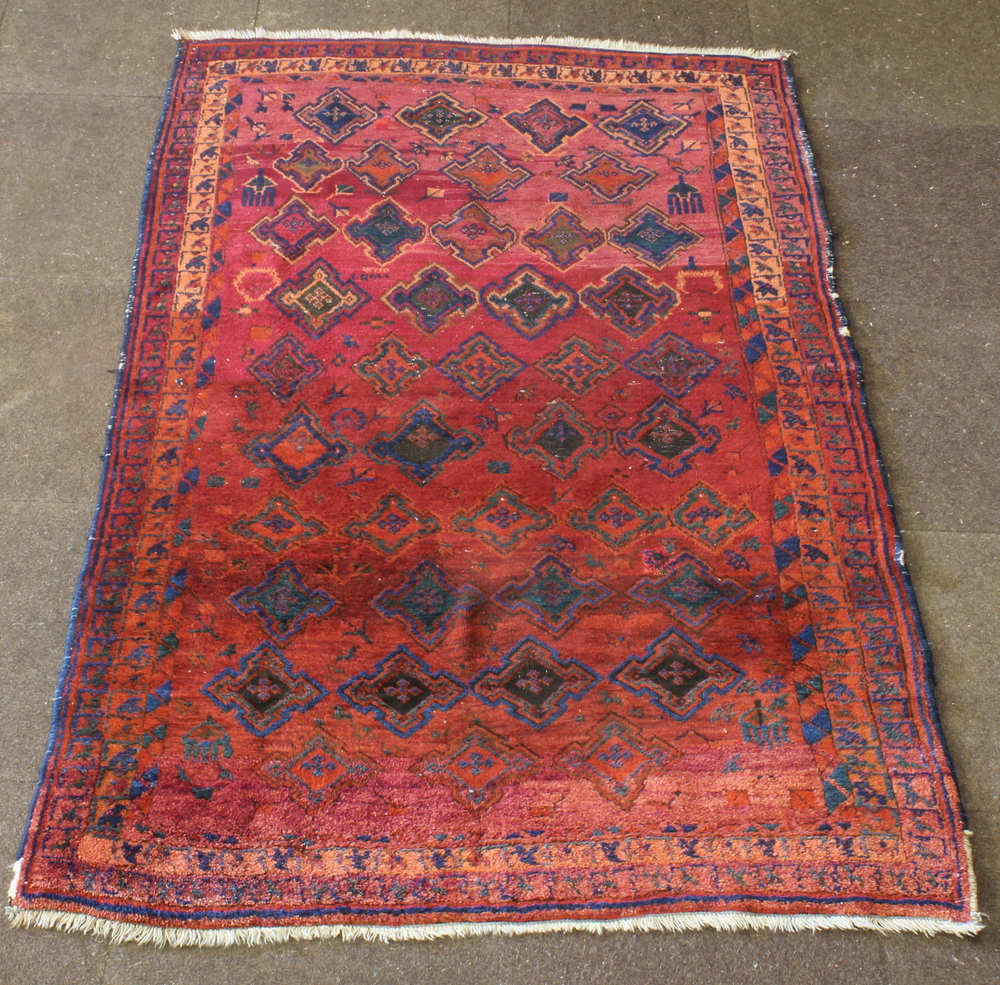 A Persian Lavar Kirman red and blue ground rug with stylised diamonds to the centre 73 1/2" x 50"