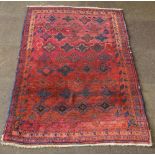 A Persian Lavar Kirman red and blue ground rug with stylised diamonds to the centre 73 1/2" x 50"