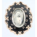 A Victorian in memorium enamelled gilt brooch with vacant locket