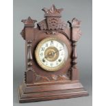 An Ansonia striking mantel clock with enamelled dial and Arabic numerals contained in a pine case