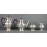 A Liberty's English pewter 4 piece planished tea service There is a dent to the hot water jug