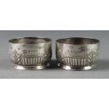 A pair of Victorian silver repousse table salts, London 1882, 76 grams