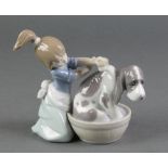 A Lladro figure of a young girl washing a hound in a barrel 5455 4"