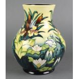 A late 20th century Moorcroft oviform vase, the blue and yellow gold decorated with irises and