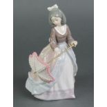 A Lladro figure of a lady holding a parasol 5210 7 1/2"