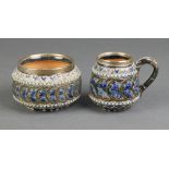 A Doulton Lambeth jug with stylised floral decoration and silver lip 2 3/4", a ditto sugar bowl 3