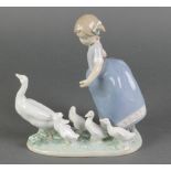 A Lladro group of a young girl with a family of geese 5503 7"