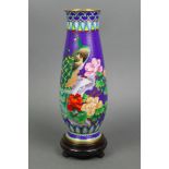A Japanese blue ground cloisonne enamelled vase decorated figures of peacocks amidst flowering