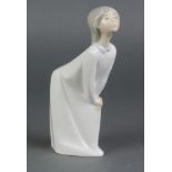 A Lladro figure of a child in a night dress 7 1/2"