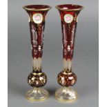 A pair of 19th Century Bohemian overlay glass tapered vases with panels of spring flowers and gilt