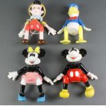 A set of 4 musical articulated Walt Disney china figures - Donald Duck, Mickey Mouse, Pluto and