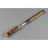 A lady's 1970's Waterman fountain pen with chequer decorated barrel and 18ct nib