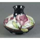 A late 20th Century Moorcroft squat baluster vase, the blue ground decorated with flowers 4"