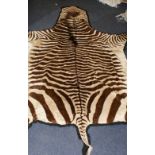 Zebra skin floor rug