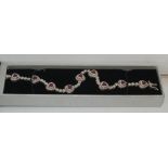 Ladies silver bracelet set with red stones