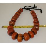 Large stringed set of African amber coloured trading beads
