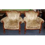 Pair of Victorian style lounge chairs with carved wooden decoration