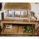 Large dolls house on play stand with lower drawer which pulls out to reveal farm