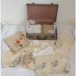 Vintage suitcase with large collection of various linen