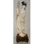 19th century Impressive and finely carved Ivory figure of a Geisha Girl holding a vase of flowers on