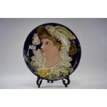 A LATE 19TH CENTURY ART NOUVEAU INFLUENCE CONTINENTAL POTTERY WALL PLAQUE decorated with a female