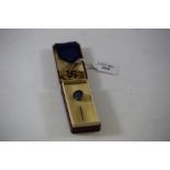 A GERMAN WWII STYLE "LONG SERVICE" GILT METAL CROSS AND RIBBON and a ditto German "SS" STICKPIN,