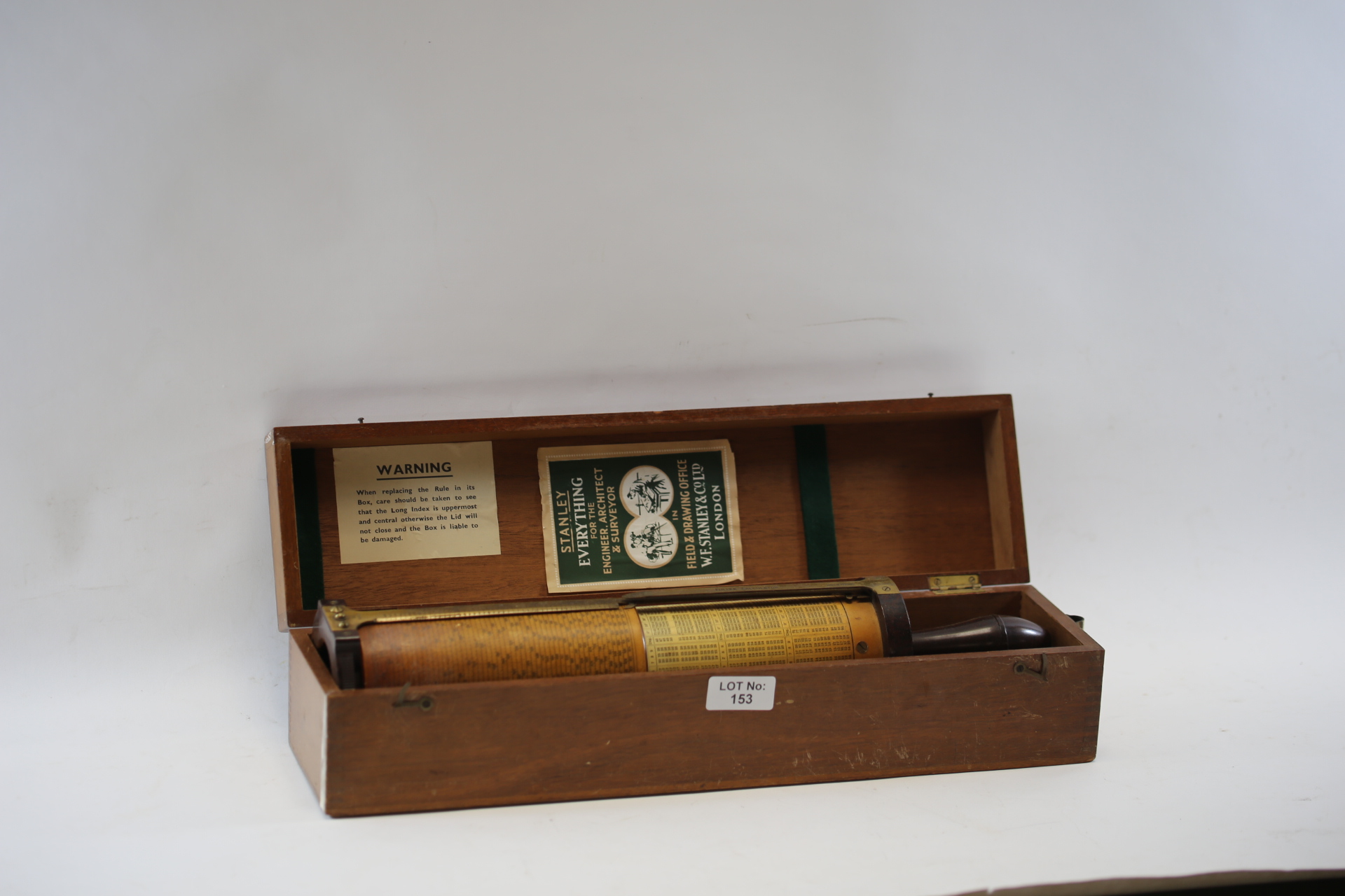 A 20TH CENTURY STANLEY FULLER CALCULATOR OF CYLINDRICAL FORM, 17 ins long with original mahogany