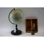 AN EARLY 20TH CENTURY PHILIPS BRITISH EMPIRE GLOBE, 8 ins diameter on an ebonised stand and a