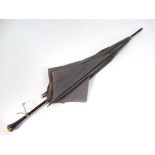 An umbrella with partridge wood shaft and having damascene decoration to handle marked 'S Fox & Co
