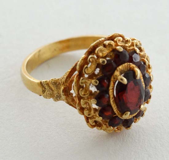 An 18ct gold ring set with garnets  CONDITION: Please Note -  we do not make reference to the