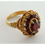 An 18ct gold ring set with garnets  CONDITION: Please Note -  we do not make reference to the