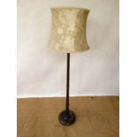 An early - mid 20thC turned walnut standard lamp with circular base and damask silk shade 66 3/4"