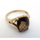 A 9ct gold ring set with facet cut smoky quartz stone  CONDITION: Please Note -  we do not make