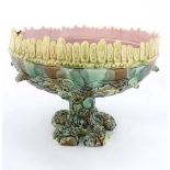 A 19thC large Majolica pedestal bowl. The base in the form of a tree stump with green relief