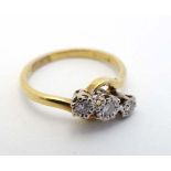 An 18ct gold ring set with trio of diamonds  CONDITION: Please Note -  we do not make reference to