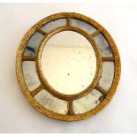 A c.1820 unusual small oval bordered glass wall mirror with Vauxhall ? glass border approx 16"