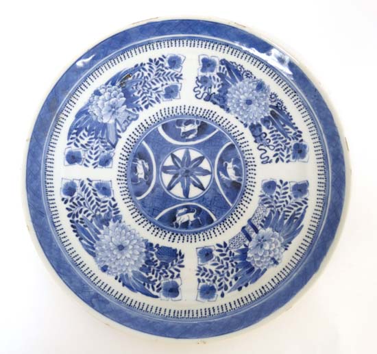 A 19thC porcelain oriental plate : A blue and white plate decorated with a five panel sections, 9