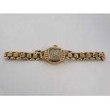 .375 gold watch : a 9ct Gold wristwatch having a square aperture dial and a gold strap and case,