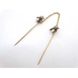 Cloak clasp : A gilt metal cloak clasp formed as 2 stick pins united by a chain, the stick pins