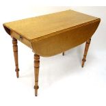 A late Victorian satinwood oval Pembroke table with drawer to one end  41 3/4" long x 20" closed