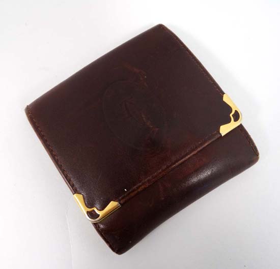 Cartier Paris : A small leather and yellow metal purse. Marked within with embossed front. 3 3/4"
