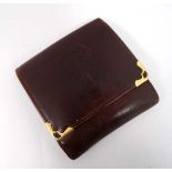 Cartier Paris : A small leather and yellow metal purse. Marked within with embossed front. 3 3/4"