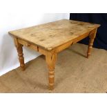 A late Victorian stripped pine kitchen table with four turned legs and drawer to one end. 35 1/4"