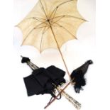 3 assorted parasols, one having a carved dogs head handle, one with black watered silk with hardwood