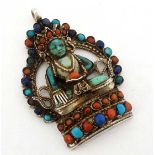 A white metal pendant formed as an Indian / Tibetan deity ?  set with turquoise, carnelian and